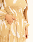 Noor champagne feather-print dress, close view of the shirred waist and tiered skirt