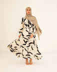 Rania monochrome print abaya, front view with the skirt in movement